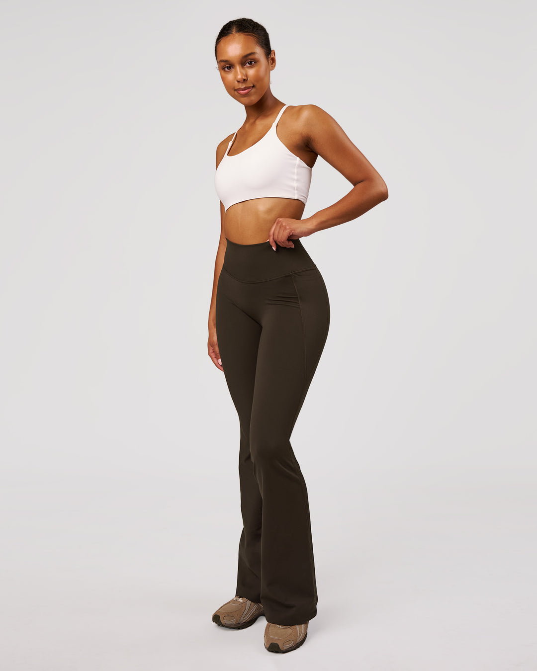 Woman wearing Fusion V-Contour High-Rise Flared Legging Pockets - Ground Coffee | Model:Jordan | Size:S - view 8