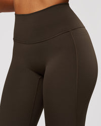 Woman wearing Fusion V-Contour High-Rise Flared Legging Pockets - Ground Coffee | Model:Jordan | Size:S | Thumbnail Index: 6
