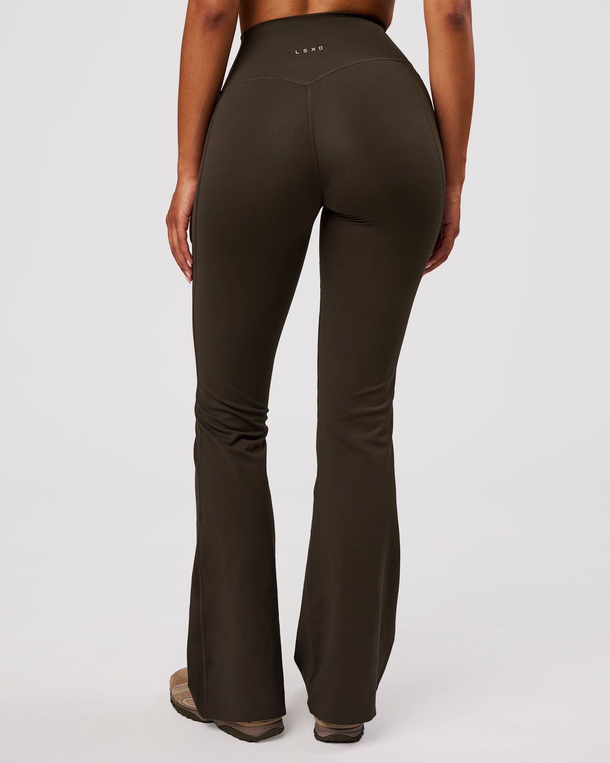Woman wearing Fusion V-Contour High-Rise Flared Legging Pockets - Ground Coffee | Model:Jordan | Size:S