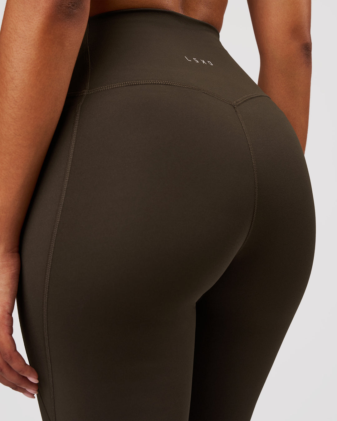 Woman wearing Fusion V-Contour High-Rise Flared Legging Pockets - Ground Coffee | Model:Jordan | Size:S - view 5