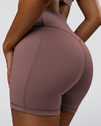 Woman wearing Fusion V-Contour Ultra High-Rise 4" Short Pockets - Cocoa Powder | Model:Jordan | Size:S | Thumbnail Index: 0