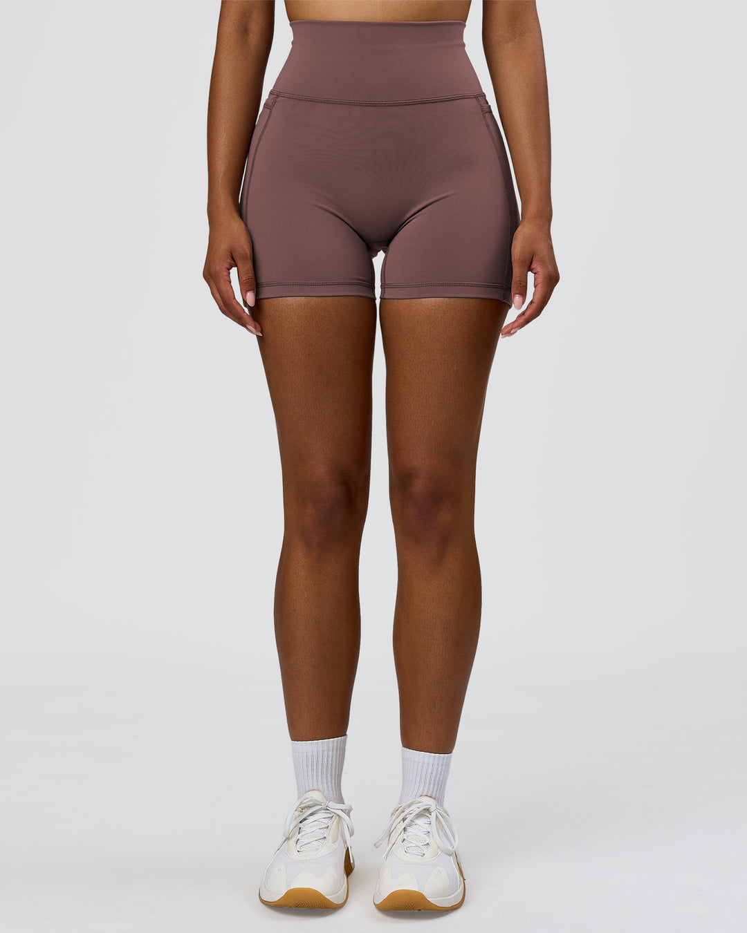 Woman wearing Fusion V-Contour Ultra High-Rise 4" Short Pockets - Cocoa Powder | Model:Jordan | Size:S - view 6