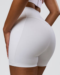 Woman wearing Fusion V-Contour Ultra High-Rise 4" Short Pockets - White | Model:Jordan | Size:S | Thumbnail Index: 0