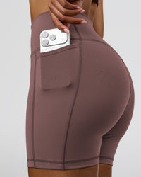 Woman wearing Fusion V-Contour Ultra High-Rise 6" Short Pockets - Cocoa Powder | Model:Jordan | Size:S | Thumbnail Index: 0