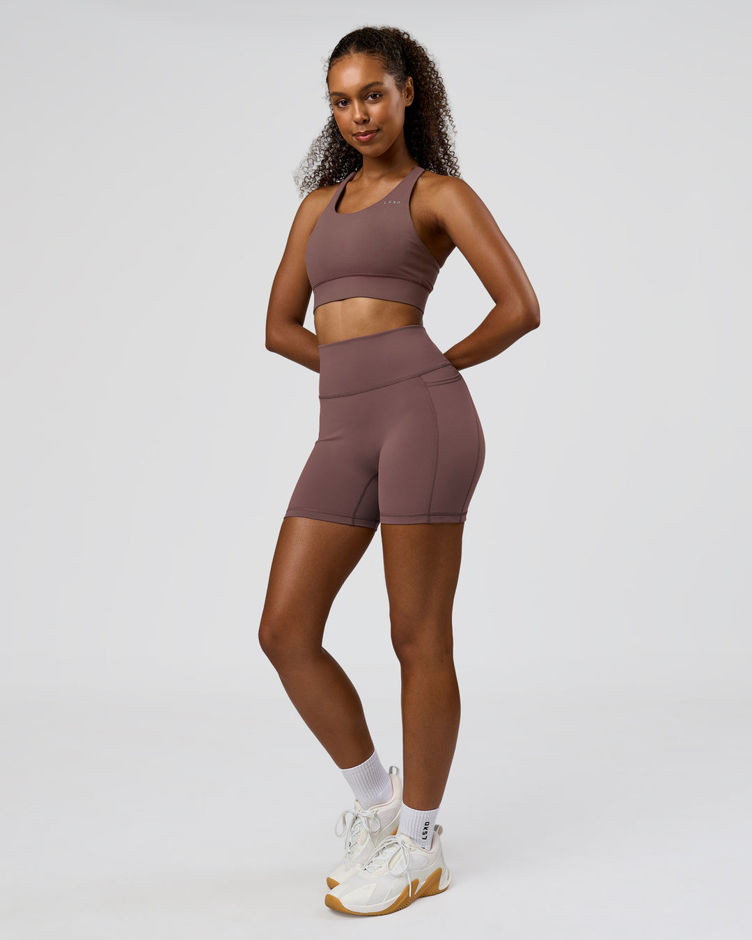 Woman wearing Fusion V-Contour Ultra High-Rise 6" Short Pockets - Cocoa Powder | Model:Jordan | Size:S - view 8