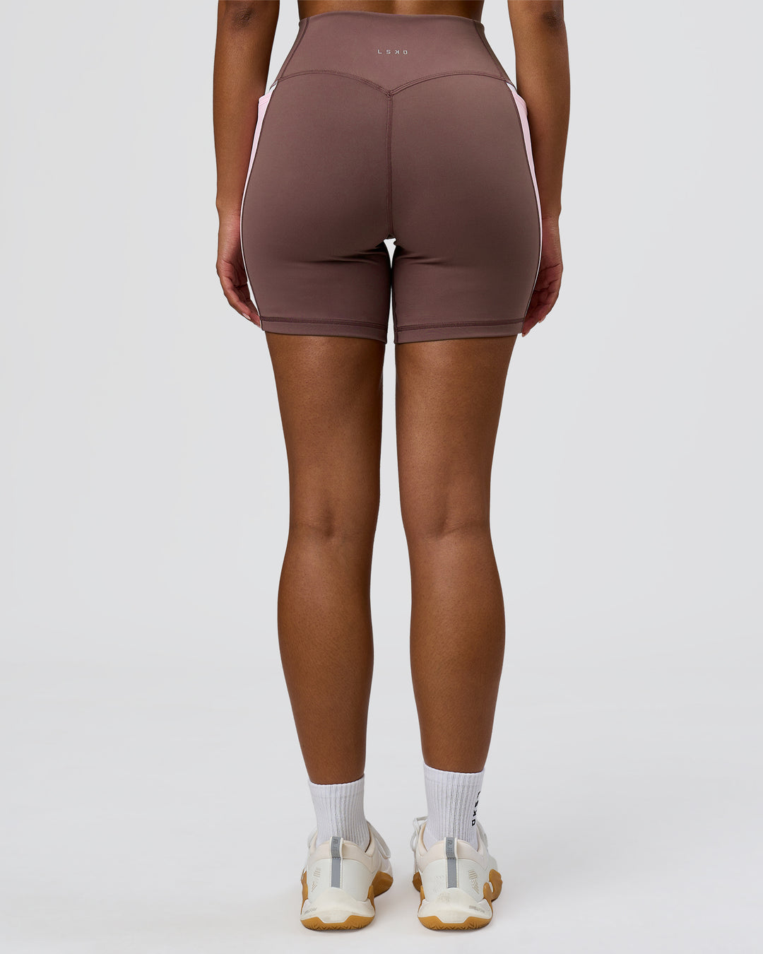 Woman wearing Fusion V-Contour Ultra High-Rise 6" Short Pockets - Cocoa Powder | Model:Jordan | Size:S - view 9
