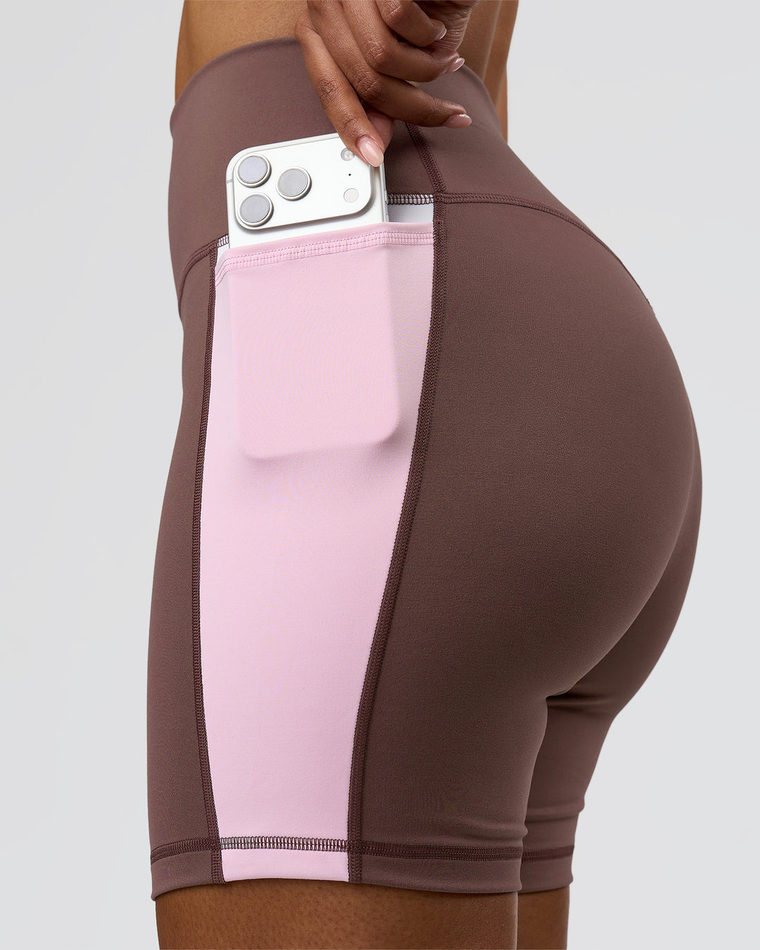Woman wearing Fusion V-Contour Ultra High-Rise 6" Short Pockets - Cocoa Powder-Marshmallow-White | Model:Jordan | Size:S - view 1