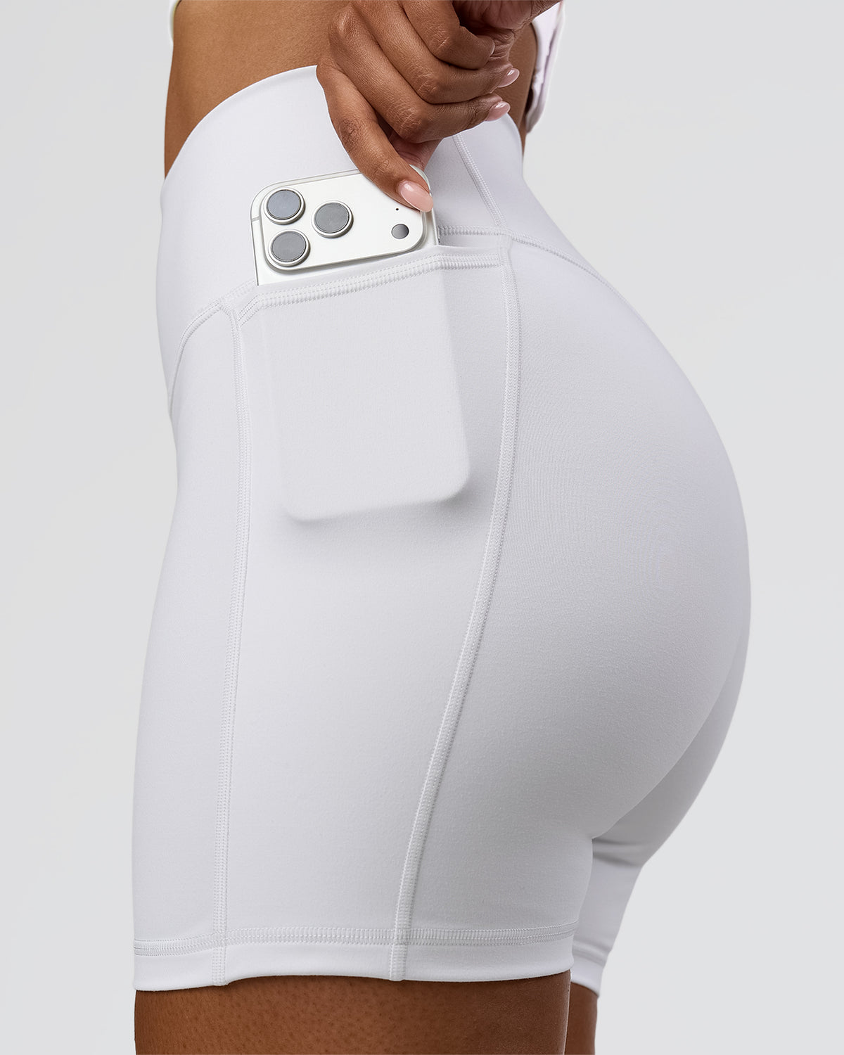 Woman wearing Fusion V-Contour Ultra High-Rise 6" Short Pockets - White | Model:Jordan | Size:S - view 1