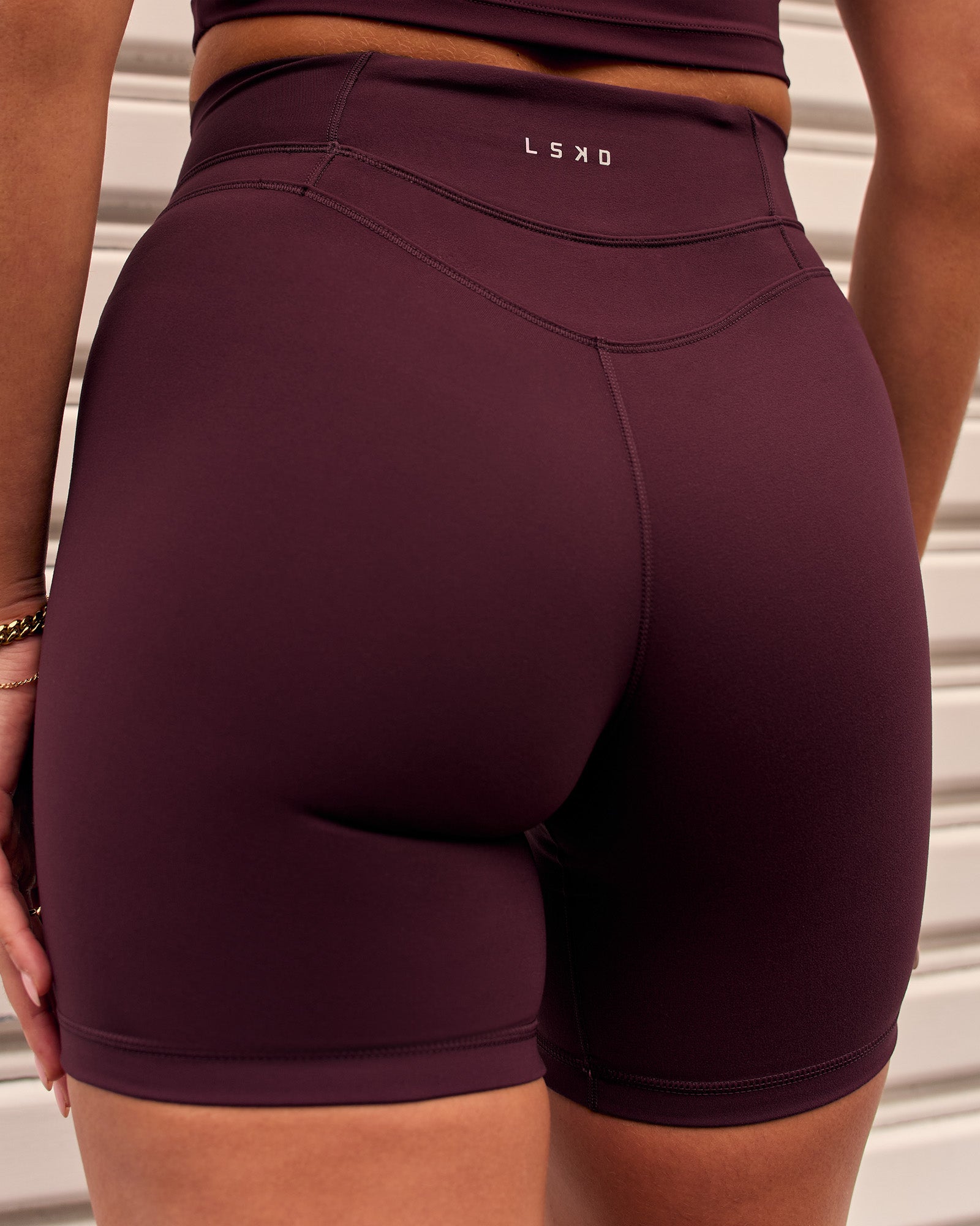 Woman wearing Solstice High-Rise 6" Short - Cherry Lacquer | Model:Remy | Size:S