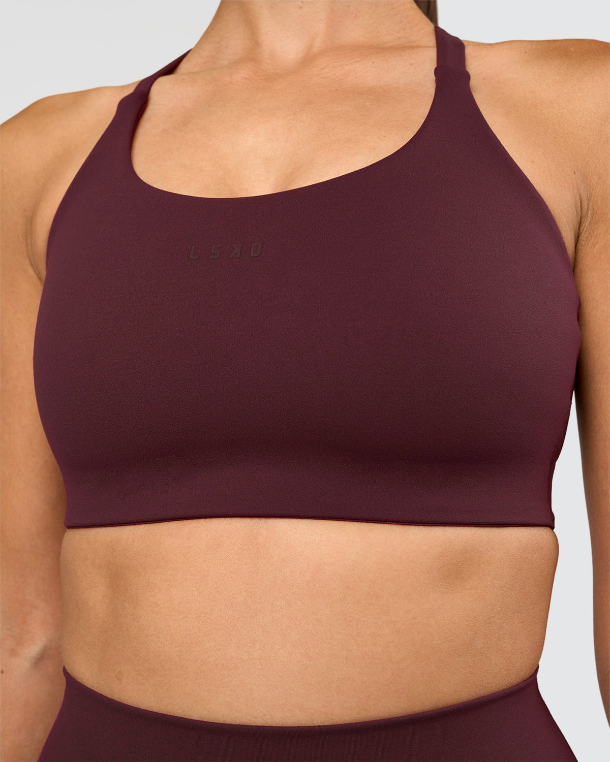 Woman wearing Twist Sports Bra D/DD/E - Cherry Lacquer | Model:Rhiley | Size:S - view 2