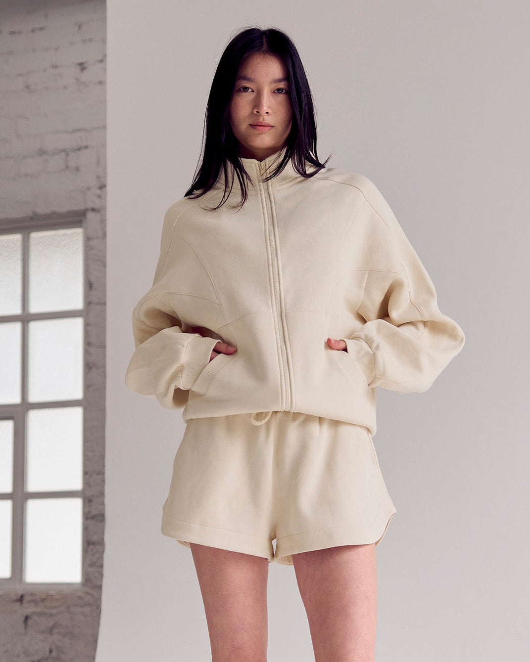 Woman wearing Bree Fleece Track Short - Vanilla Bean | Model:Rianna | Size:S
