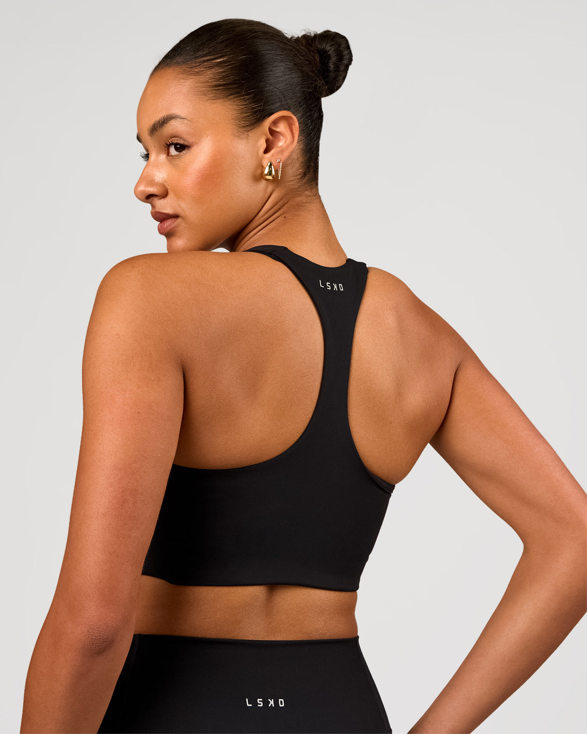 Woman wearing Flow Long Line Sports Bra - Black | Model:Rosie | Size:S