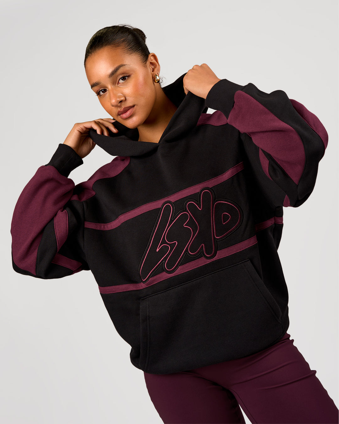 Woman wearing Vibe Oversized Hoodie - Black-Cherry Lacquer | Model:Rosie | Size:S - view 7