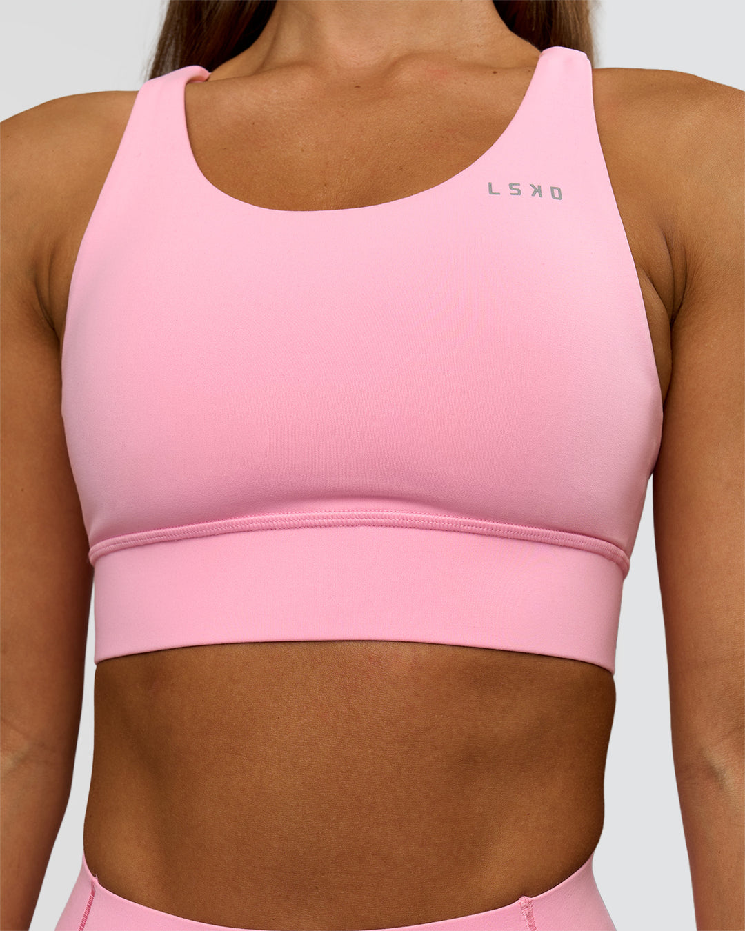 Woman wearing Accelerate Sports Bra - Pink Rose | Model:Brylee | Size:XS