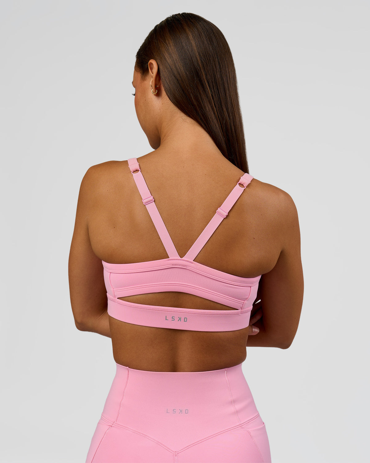 Woman wearing Momentum Sports Bra - Pink Rose | Model:Brylee | Size:XS