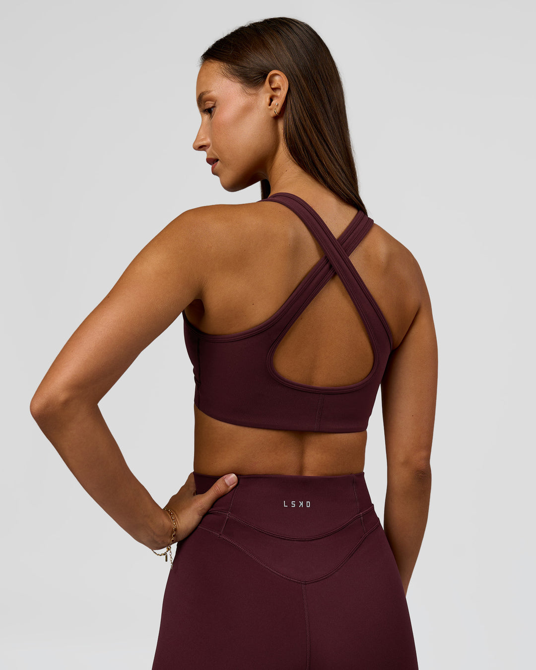 Woman wearing Stamina Sports Bra - Cherry Lacquer | Model:Brylee | Size:XS - view 2