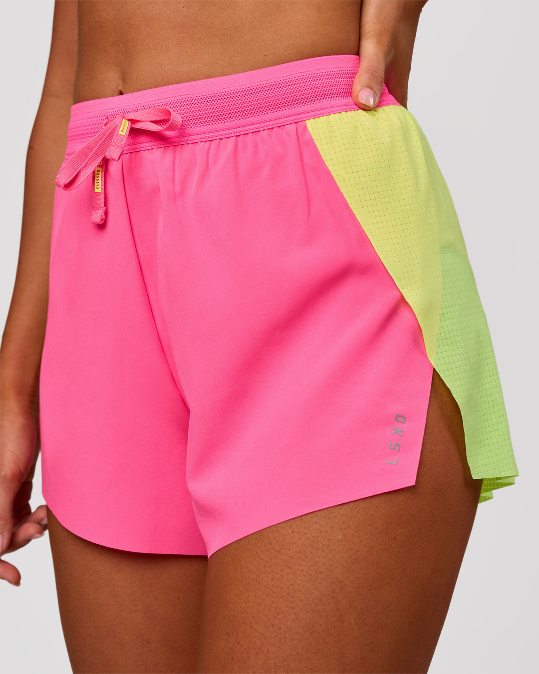 Woman wearing Accelerate 3" High-Rise Running Short - Lime Glo-Sugar Plum | Model:Charli | Size:XS - view 1