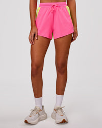 Woman wearing Accelerate 3" High-Rise Running Short - Lime Glo-Sugar Plum | Model:Charli | Size:XS | Thumbnail Index: 6