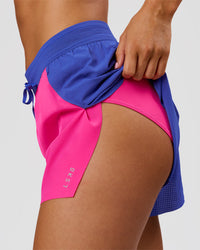 Woman wearing Accelerate 3" High-Rise Running Short - Power Cobalt-Ultra Pink | Model:Charli | Size:XS | Thumbnail Index: 6