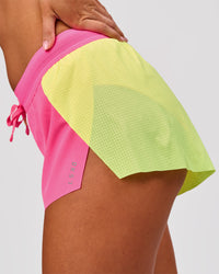 Woman wearing Accelerate 3" Mid-Rise Running Short - Lime Glo-Sugar Plum | Model:Charli | Size:XS | Thumbnail Index: 9