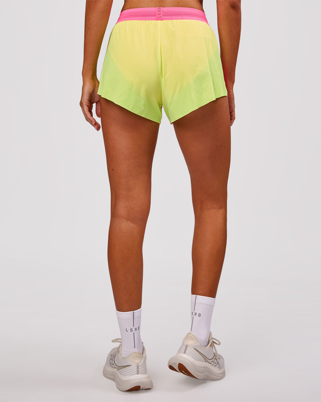 Woman wearing Accelerate 3" Mid-Rise Running Short - Lime Glo-Sugar Plum | Model:Charli | Size:XS - view 6