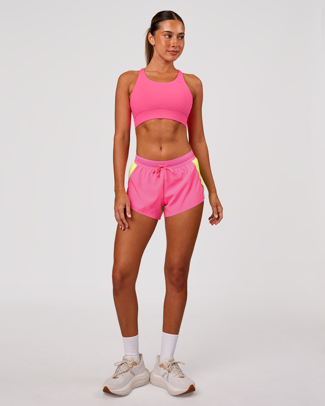 Woman wearing Accelerate 3" Mid-Rise Running Short - Lime Glo-Sugar Plum | Model:Charli | Size:XS - view 3