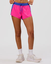 Woman wearing Accelerate 3" Mid-Rise Running Short - Power Cobalt- Ultra Pink | Model:Charli | Size:XS | Thumbnail Index: 3