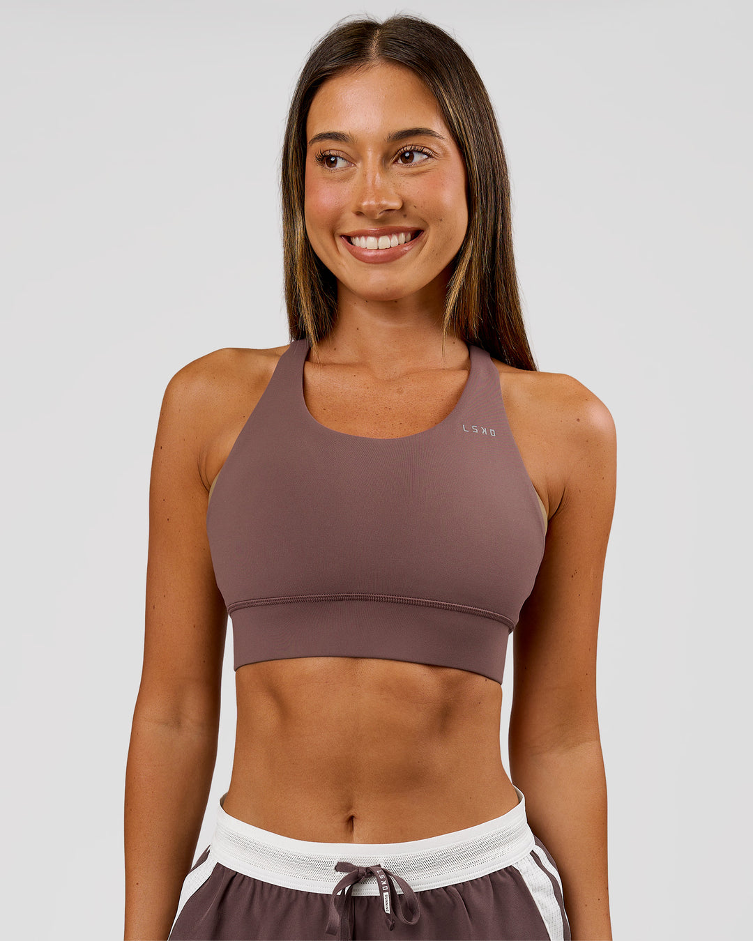 Woman wearing Accelerate Sports Bra - Cocoa Powder | Model:Charli | Size:XS - view 2