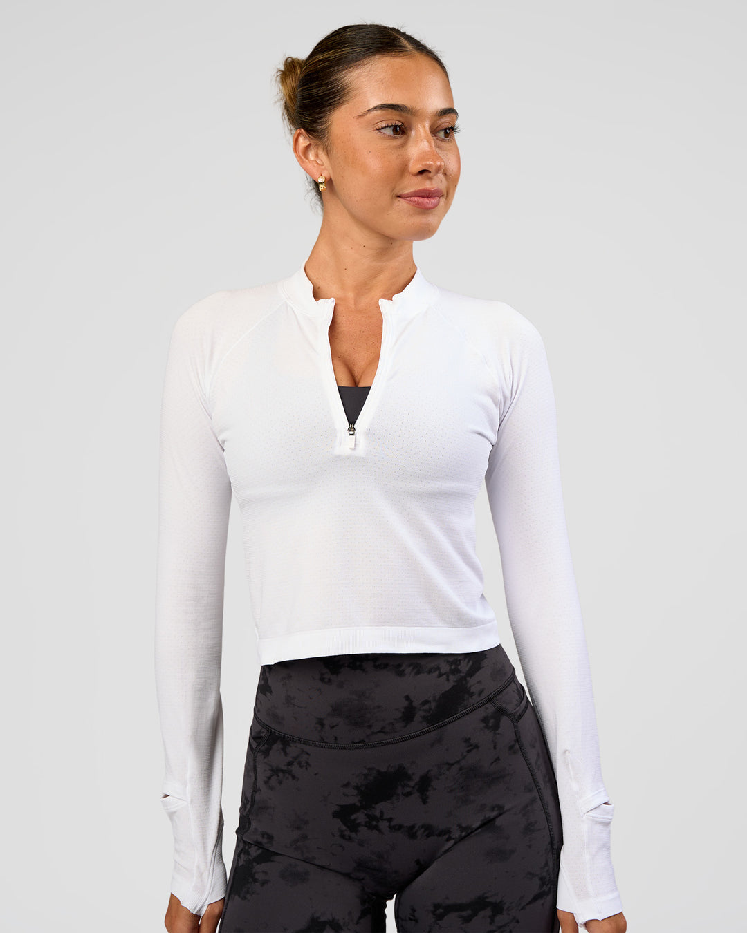 Woman wearing AeroFLX+ Long Sleeve Skimmer Half Zip - White/White | Model:Charli | Size:XS - view 1