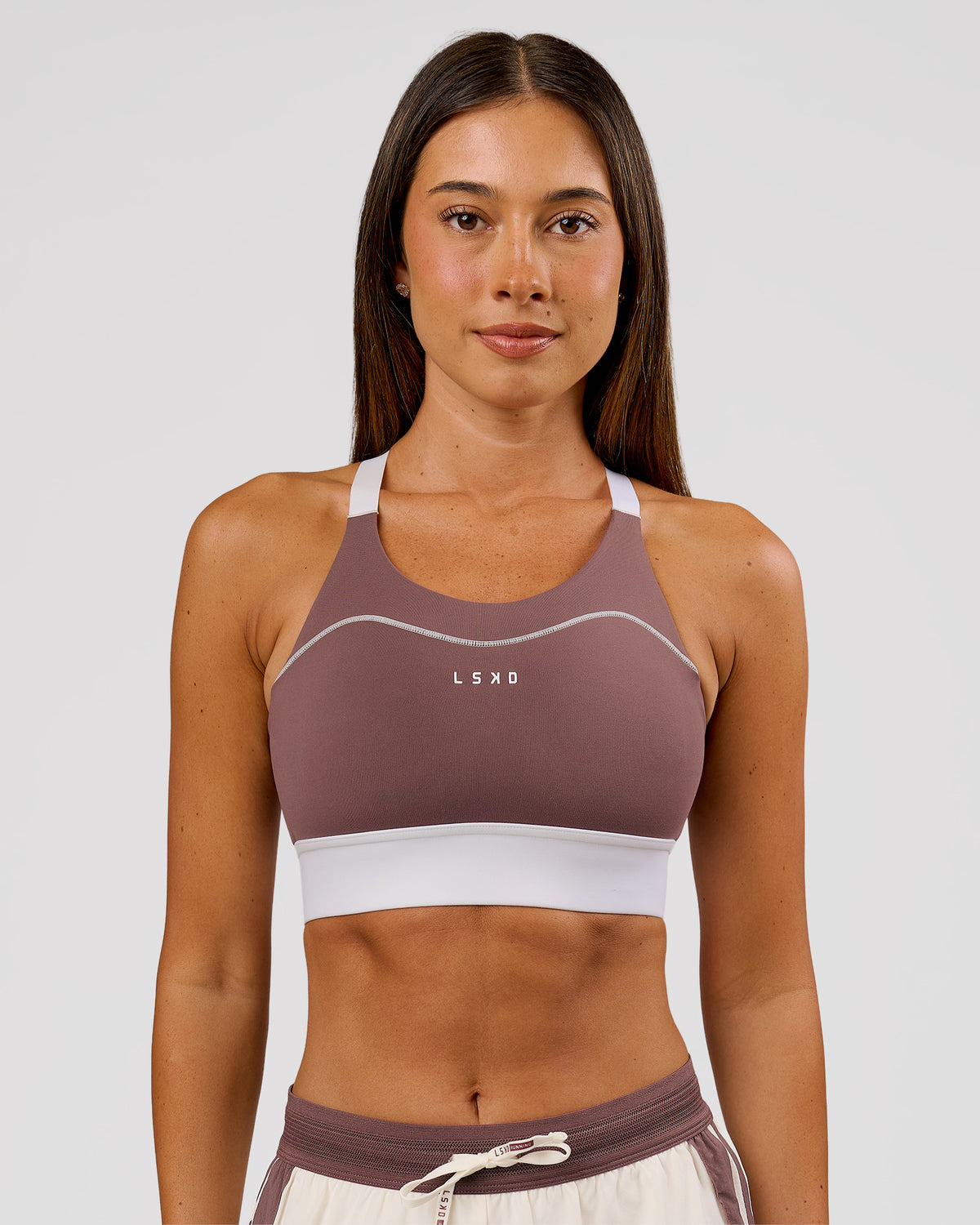 Woman wearing Elevated Accelerate Sports Bra - Cocoa Power-White | Model:Charli | Size:XS - view 2