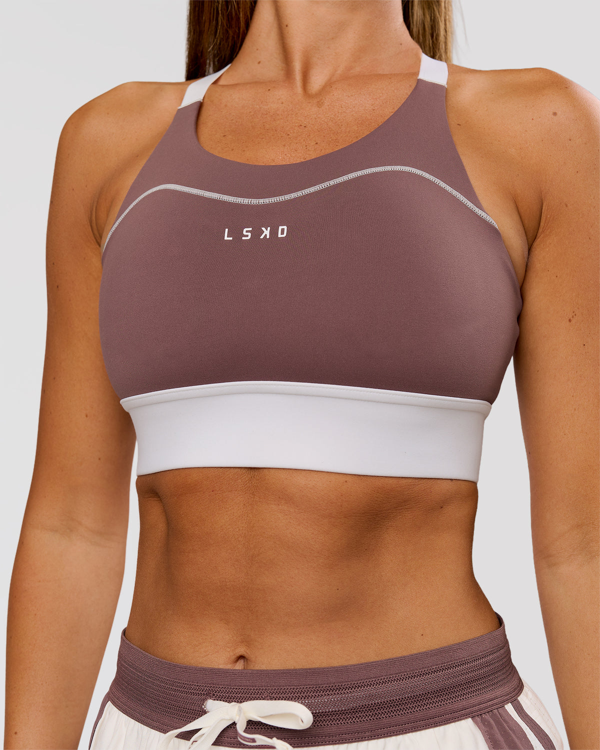 Woman wearing Elevated Accelerate Sports Bra - Cocoa Power-White | Model:Charli | Size:XS - view 1
