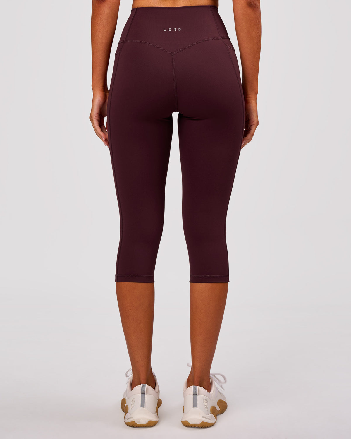 Woman wearing Fusion V Contour Ultra High-Rise 3/4 Legging Pockets - Cherry Lacquer | Model:Charli | Size:XS - view 1