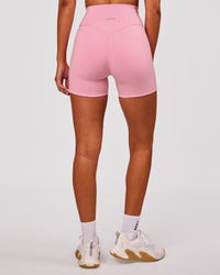 Woman wearing Fusion V-Contour Ultra High-Rise 4" Short Pockets - Pink Rose | Model:Charli | Size:XS | Thumbnail Index: 2