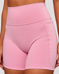 Woman wearing Fusion V-Contour Ultra High-Rise 6" Short Pockets - Pink Rose | Model:Charli | Size:XS | Thumbnail Index: 2