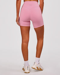 Woman wearing Fusion V-Contour Ultra High-Rise 6" Short Pockets - Pink Rose | Model:Charli | Size:XS | Thumbnail Index: 4