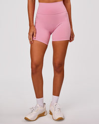 Woman wearing Fusion V-Contour Ultra High-Rise 6" Short Pockets - Pink Rose | Model:Charli | Size:XS | Thumbnail Index: 5
