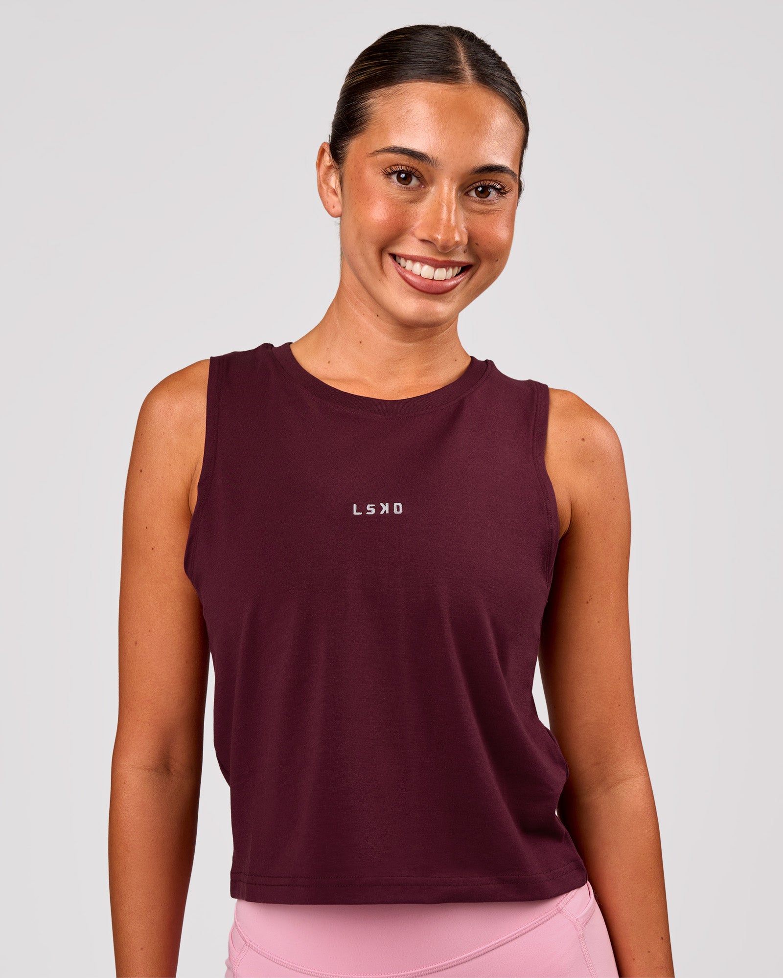 Woman wearing Go-To FLXCotton Midline Tank - Cherry Lacquer-White | Model:Charli | Size:XS