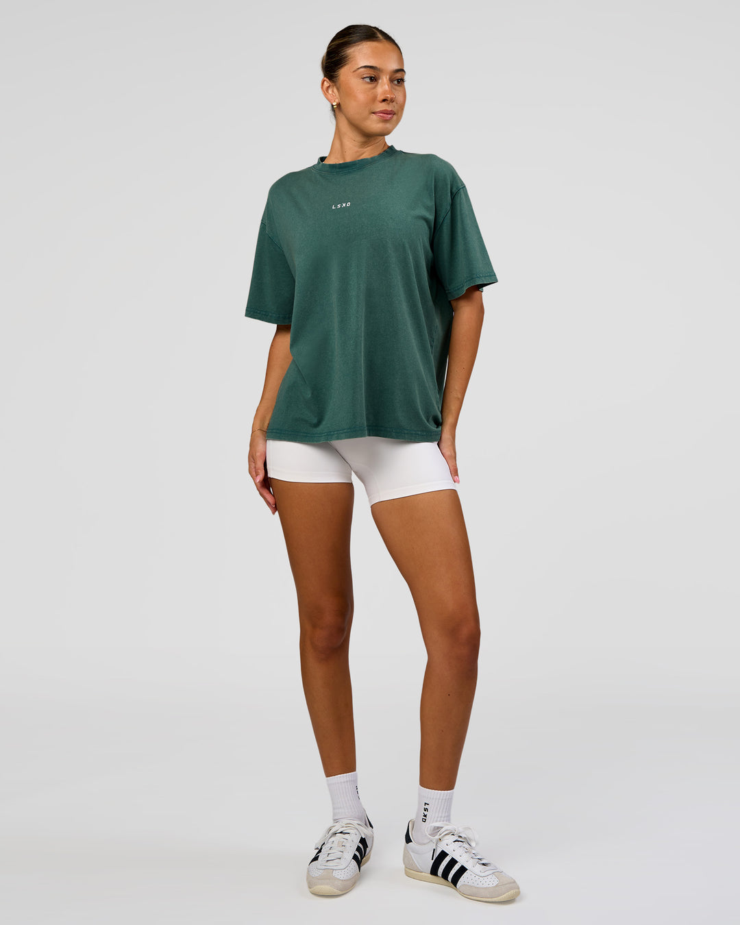 Woman wearing Go-To FLXCotton Oversized Tee - Transformative Teal Washed-White | Model:Charli | Size:XS