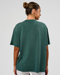 Woman wearing Go-To FLXCotton Oversized Tee - Transformative Teal Washed-White | Model:Charli | Size:XS