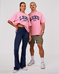 Woman wearing Varsity EST Heavyweight Oversized Tee  - Pink Rose-Future Navy | Model:Charli | Size:XS | Thumbnail Index: 1
