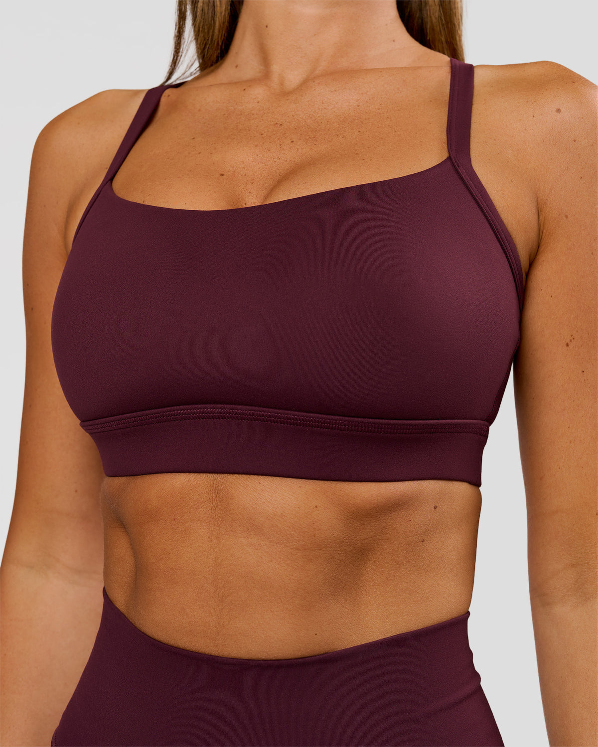Woman wearing Momentum Sports Bra D/DD/E - Cherry Lacquer | Model:Charli | Size:XS - view 1