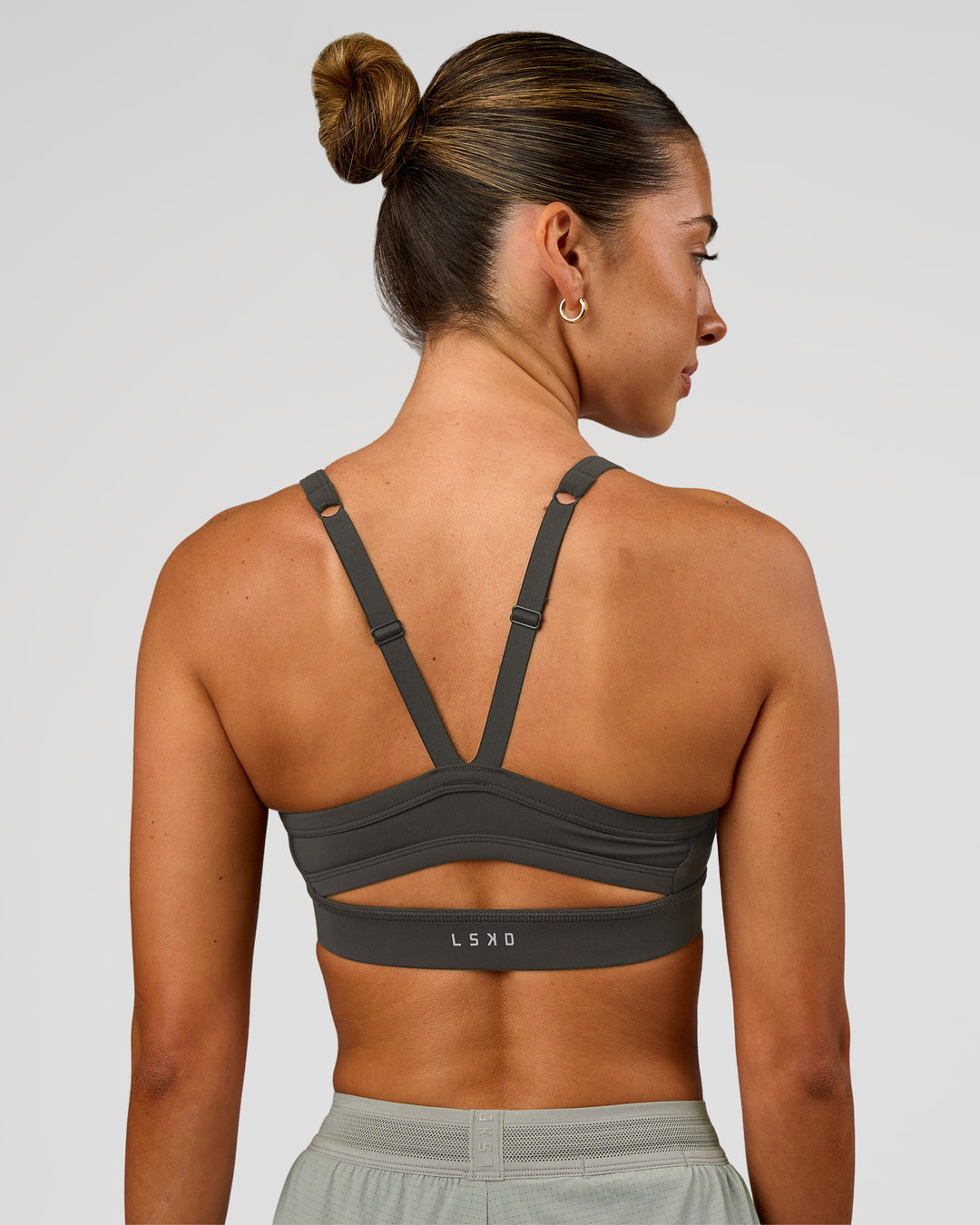 Woman wearing Momentum Sports Bra - Onyx | Model:Charli | Size:XS - view 2