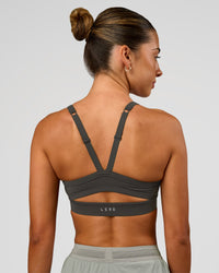 Woman wearing Momentum Sports Bra - Onyx | Model:Charli | Size:XS | Thumbnail Index: 1