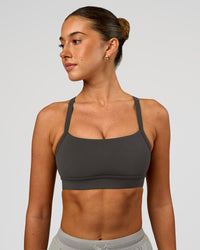 Woman wearing Momentum Sports Bra - Onyx | Model:Charli | Size:XS | Thumbnail Index: 0