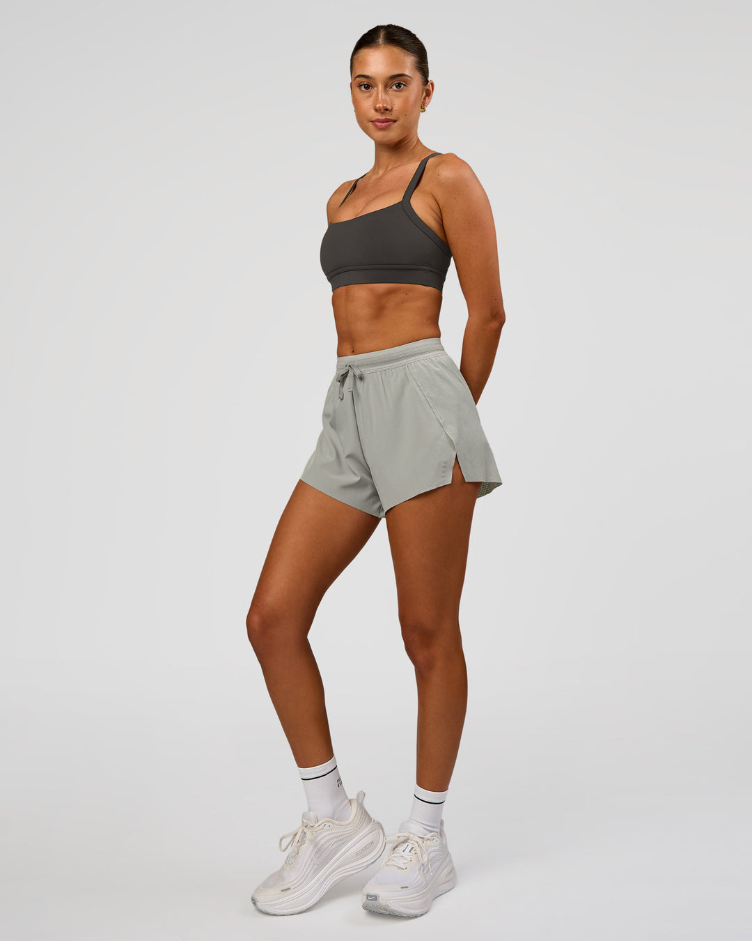 Woman wearing Momentum Sports Bra - Onyx | Model:Charli | Size:XS - view 5