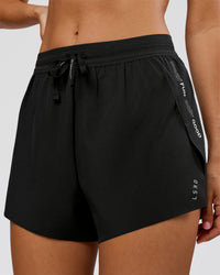Woman wearing Movember x LSKD Accelerate 3" High-Rise Running Short - Black | Model:Charli | Size:XS | Thumbnail Index: 1