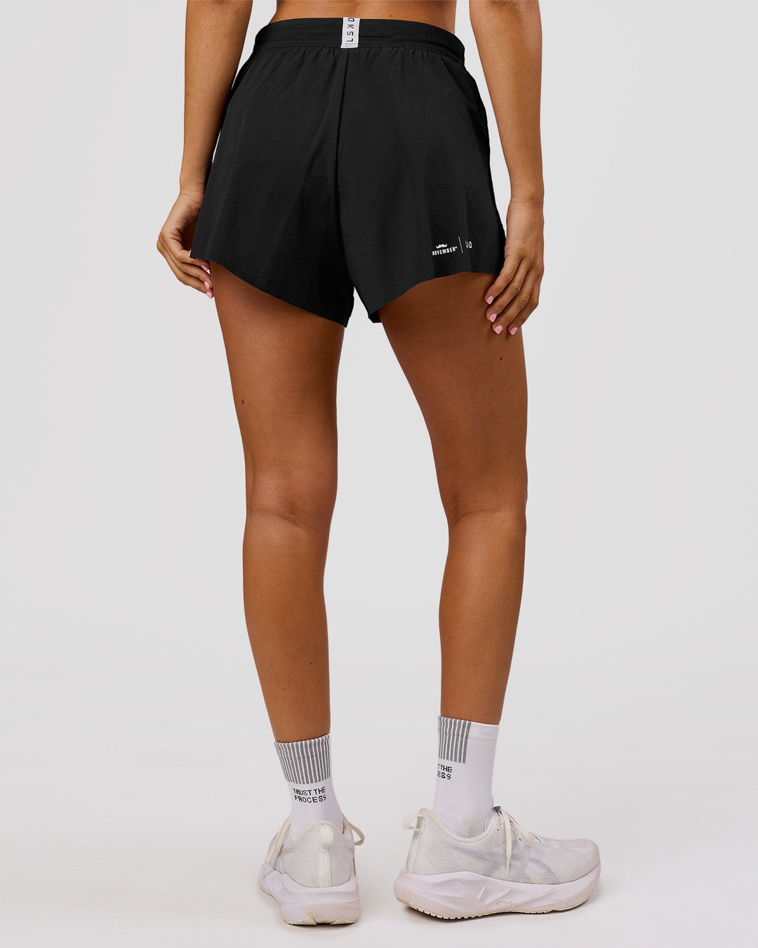 Woman wearing Movember x LSKD Accelerate 3" High-Rise Running Short - Black | Model:Charli | Size:XS - view 5