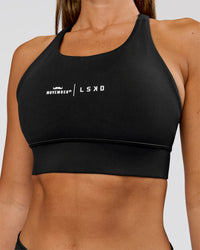 Woman wearing Movember x LSKD Accelerate Sports Bra - Black | Model:Charli | Size:XS | Thumbnail Index: 2