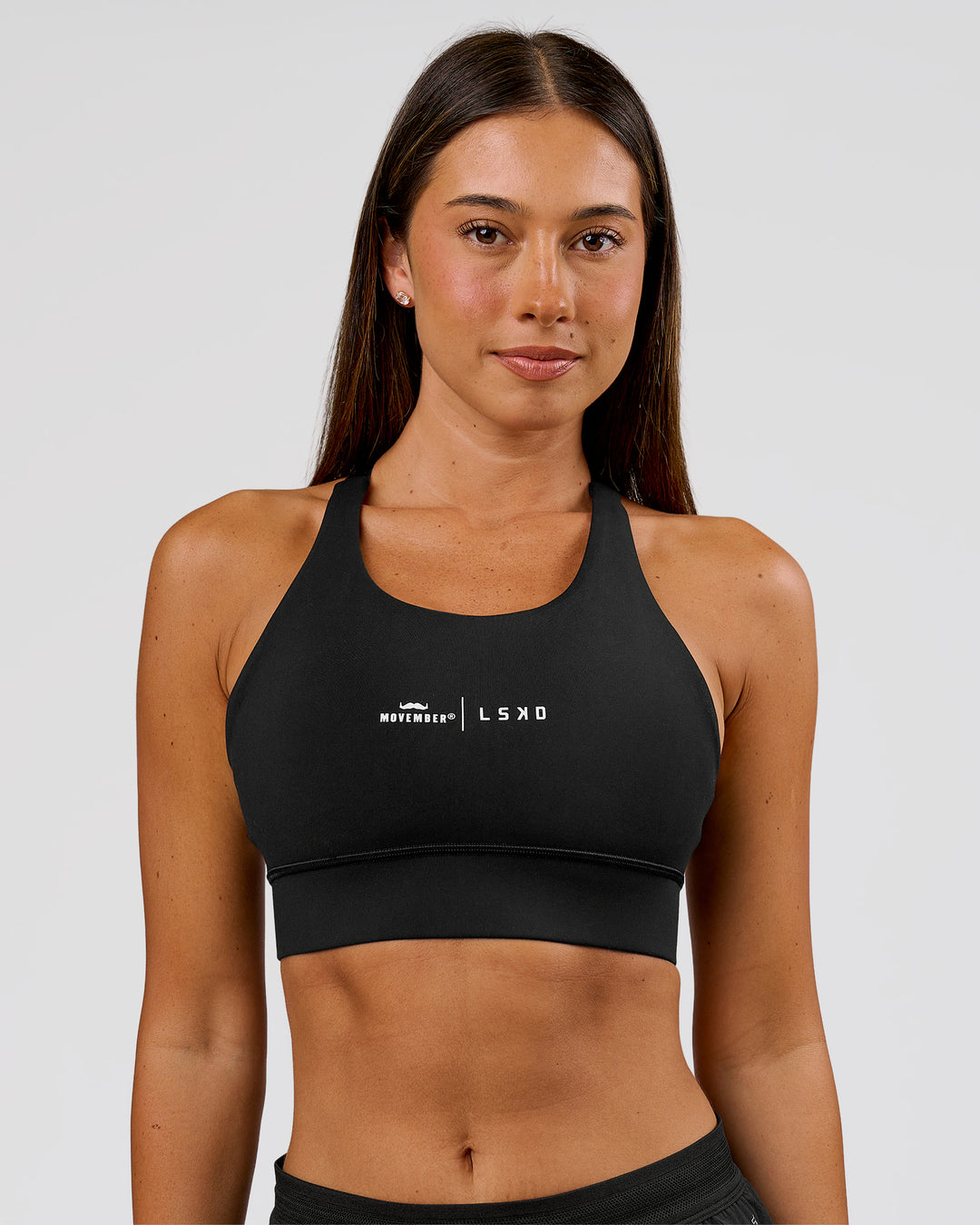 Woman wearing Movember x LSKD Accelerate Sports Bra - Black | Model:Charli | Size:XS - view 1