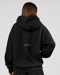 Woman wearing Movember x LSKD Oversized Hoodie - Black | Model:Charli | Size:XS | Thumbnail Index: 4